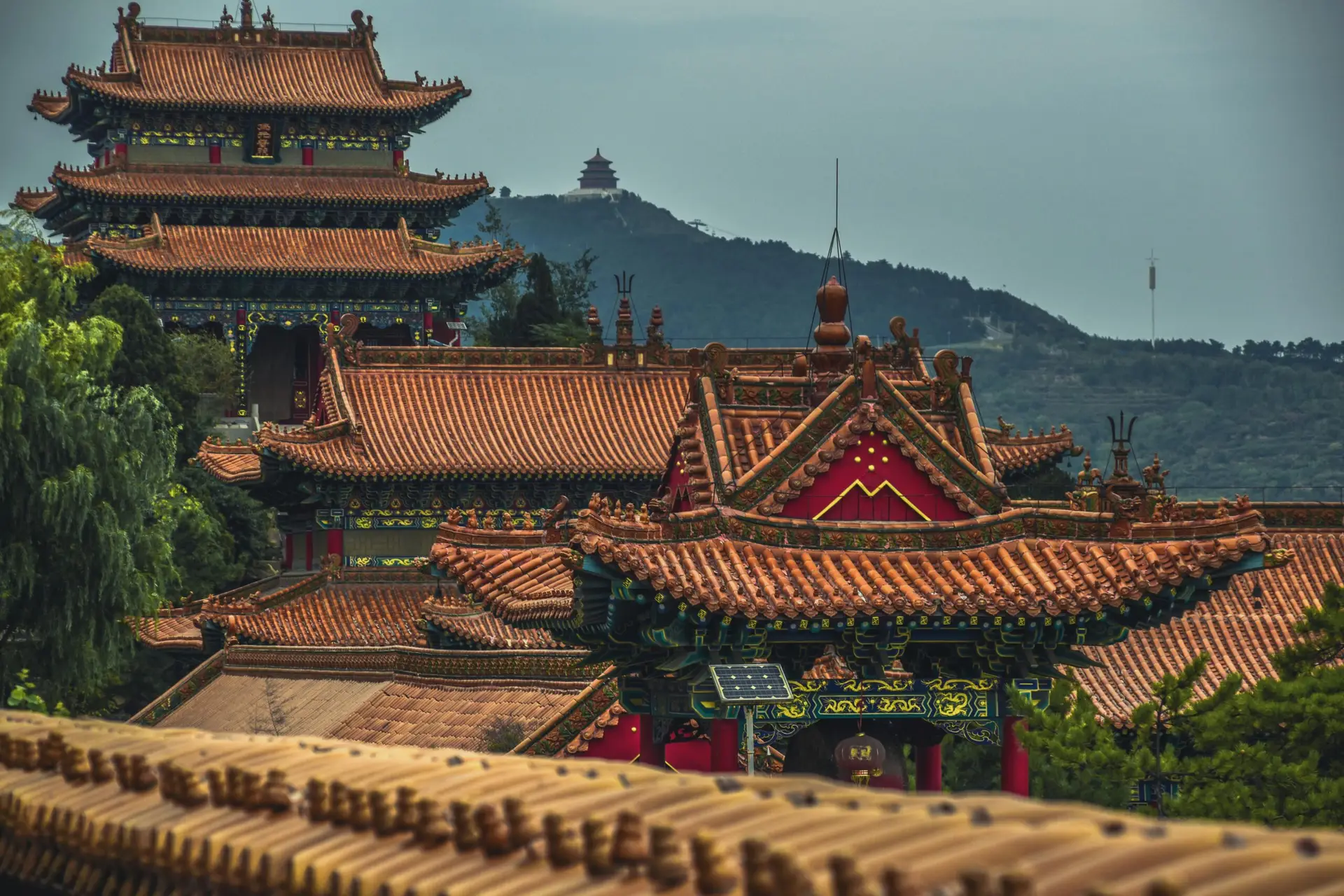 Explore the stunning ancient architecture of a Chinese pagoda in Shanxi, featuring intricate roofs and lush surroundings.